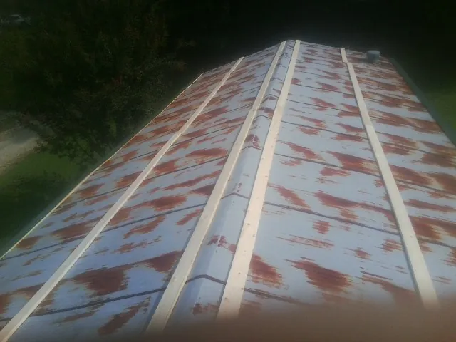 Rusted metal roof panels with new wood purlins before replacement — Storm Damage Roof Repair in Pacolet by Roofing Brothers