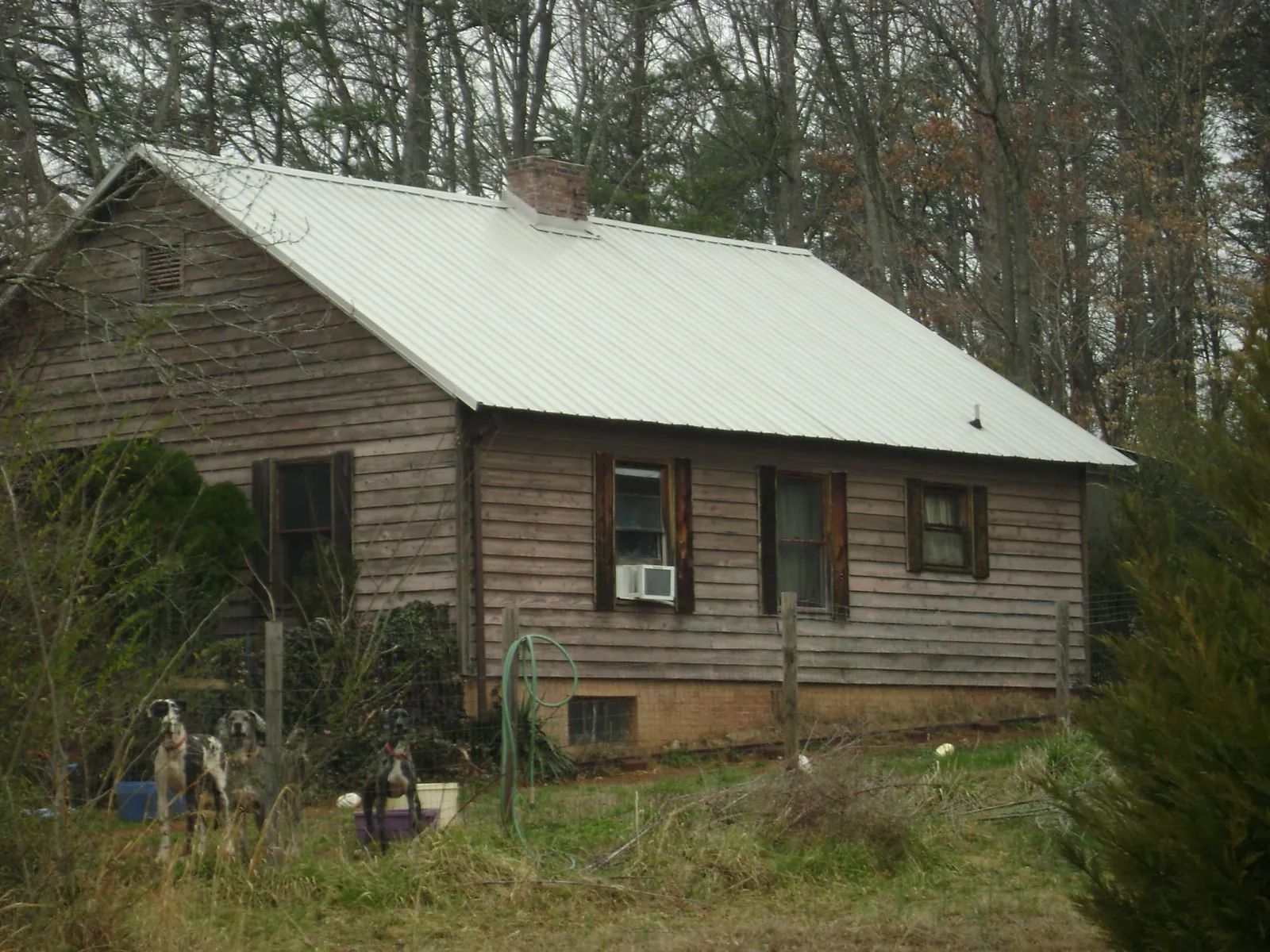 White metal roof on an old wood sided farmhouse, from a Asphalt Shingle Roof Repair job in Pacolet
